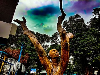 Low angle view of statue against trees