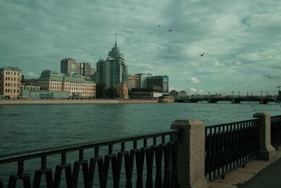 Buildings in city against cloudy sky