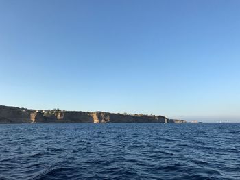 Scenic view of sea against clear blue sky