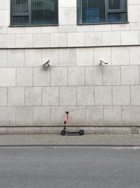 Man walking on footpath in city