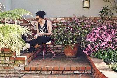 Young man sitting in garden