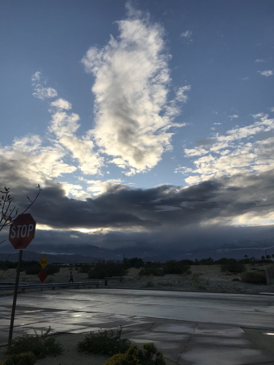 ROAD SIGN ON STREET AGAINST SKY