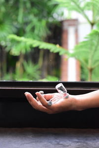 Midsection of person holding cigarette