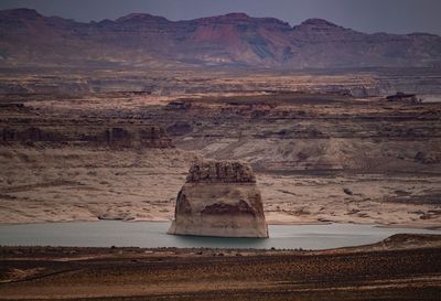 Scenic view of rock formation on land against mountains