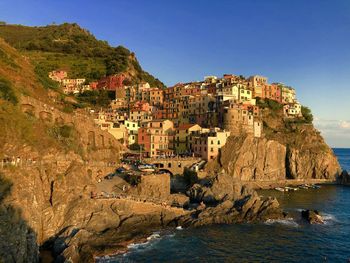 Panoramic shot of buildings by sea against sky