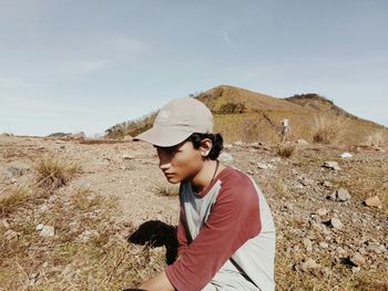 Side view of young man standing on land