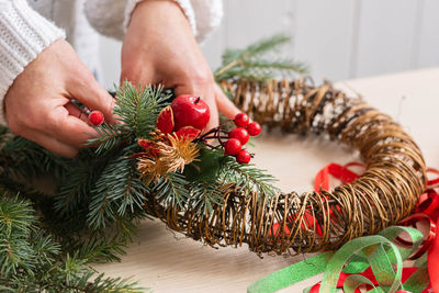 Midsection of woman holding christmas tree