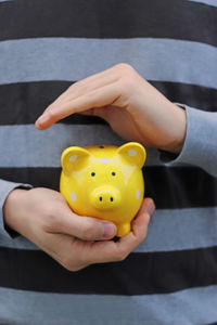 Close-up of hand holding yellow ball