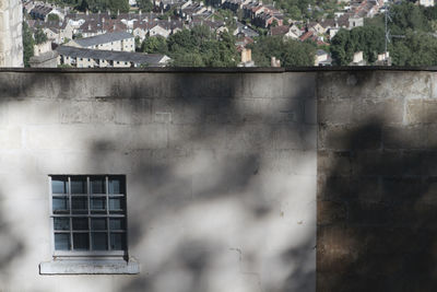 Low angle view of building seen through window