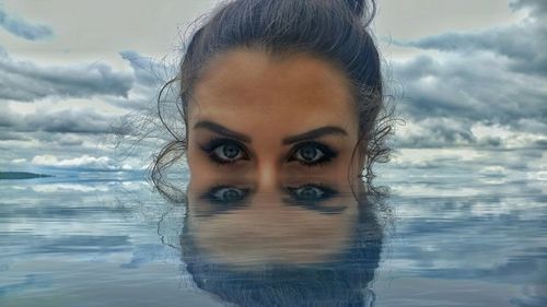 Close-up portrait of young woman against water