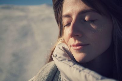 Close-up portrait of young woman looking away