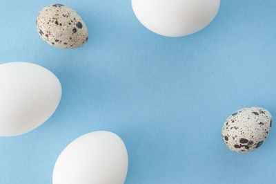 High angle view of eggs on table against blue background