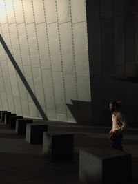 Woman standing against wall