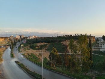 High angle view of road by buildings against sky