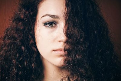 Close-up portrait of woman with curly hair