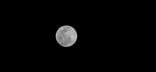 Low angle view of full moon at night sky