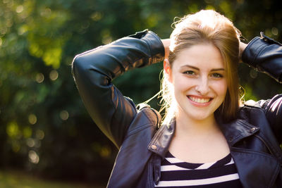 Portrait of smiling young woman standing outdoors