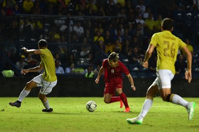 Group of people playing soccer on field