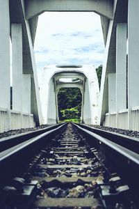 Surface level of railroad tracks against sky