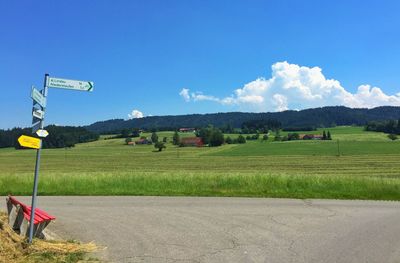 Scenic view of field against cloudy sky