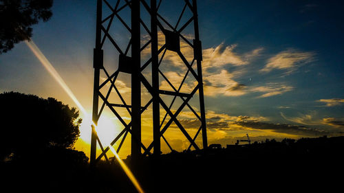 Low angle view of silhouette plants against sky at sunset