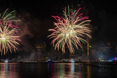 Firework display over river at night