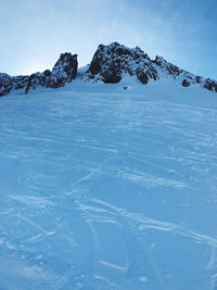 Scenic view of snowcapped mountains against blue sky