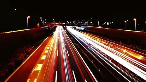 High angle view of light trails on highway at night