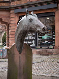 View of statue against building in city