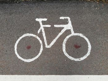 High angle view of arrow symbol on road in city
