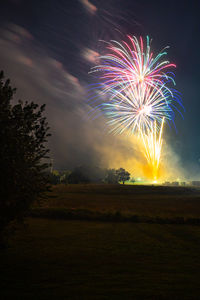 Low angle view of firework display at night