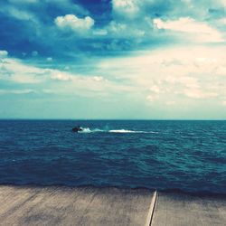 Scenic view of sea against cloudy sky