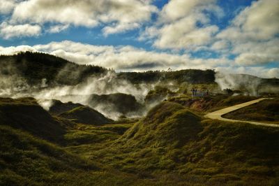 Scenic view of landscape against cloudy sky