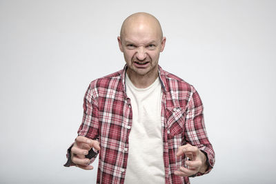 Mid adult man standing against white background