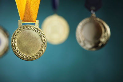 Close-up of medals hanging against blackboard