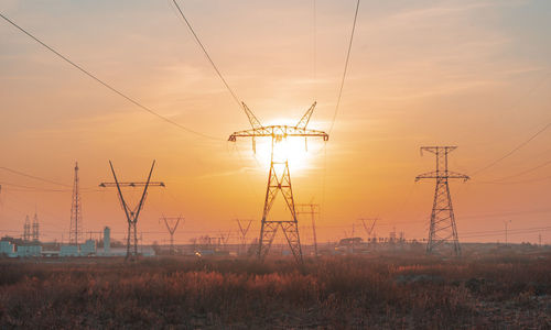 High-voltage power transmission line. energy pillars. at sunset, dawn. high-tension