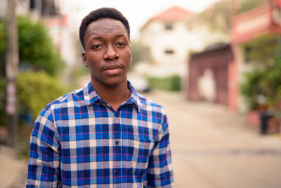 Portrait of young man standing outdoors