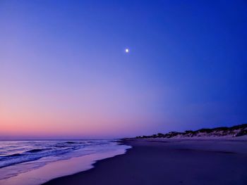 Scenic view of sea against sky at night