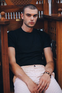 Portrait of young man sitting outdoors