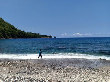 Man on beach against sky