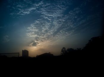 Silhouette trees against sky during sunset