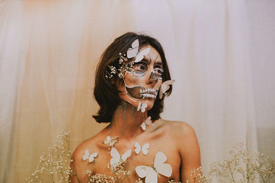 Portrait of young woman with face paint