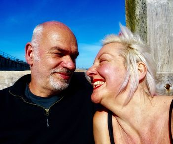 Close-up of smiling mature couple during sunny day