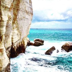 Scenic view of sea against cloudy sky