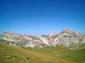 View of mountain range against blue sky