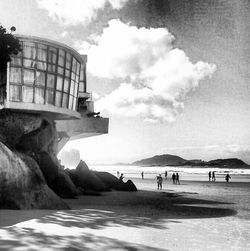 People at beach against sky