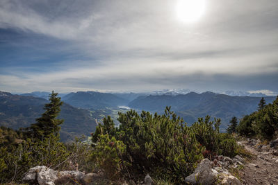 Scenic view of trees and mountains against sky