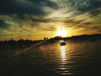 Boat in sea at sunset