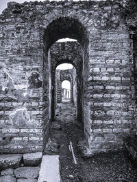 Arch in tunnel against sky