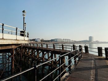 Shot from a classic british pier revealing the coastal city and the beach in the background